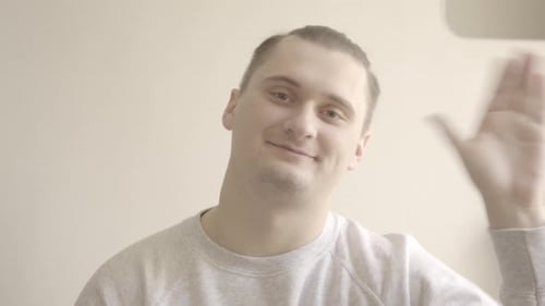 Young Adult Waving Hello Indoors