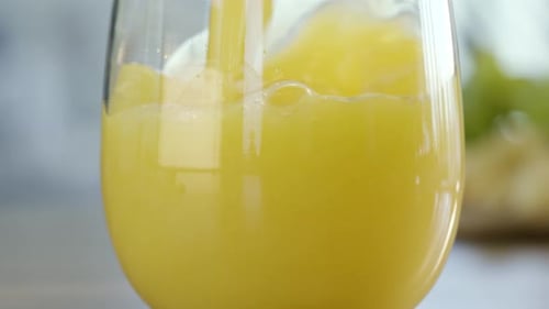 Orange Juice Poured into Clear Glass Close Up
