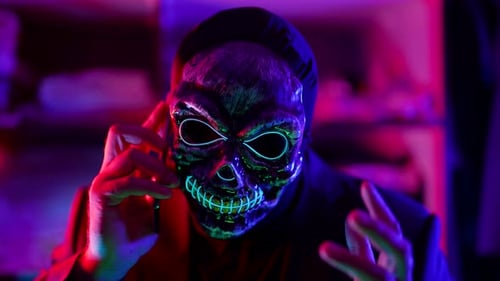 Person with Glowing Skeleton Mask Talking on Phone