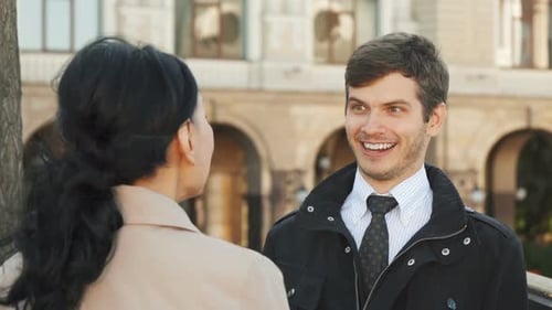 Man and Woman Conversing in City, Daytime