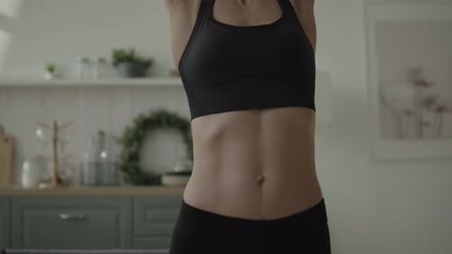 Woman Working Out with Pink Dumbbells Indoors