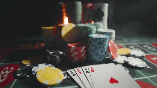 Casino Chips with Dice and Playing Cards on a Dark Table
