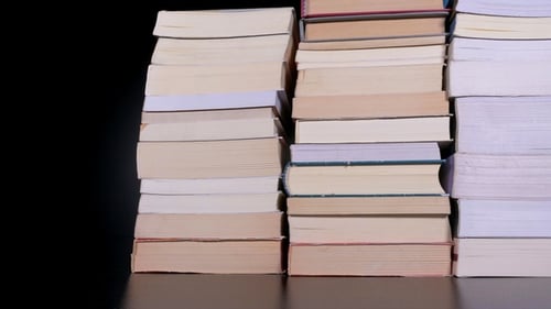 Stacks of Books Being Moved on Surface