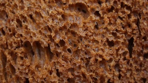 Background of Black Bread Rotating Extreme Close Up Macro Shot