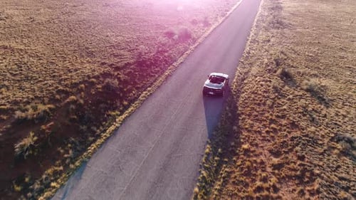 Convertible Car Driving on Desert Highway