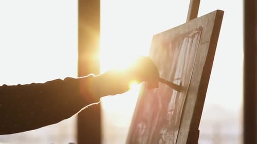 Artist Painting on Canvas During Golden Hour