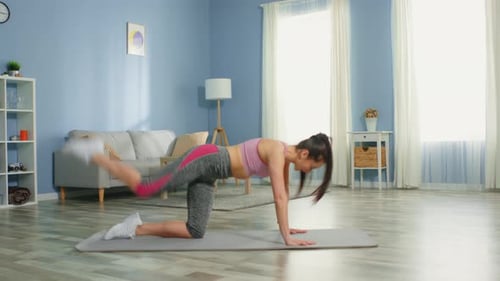 Young Woman Doing Donkey Kicks at Home