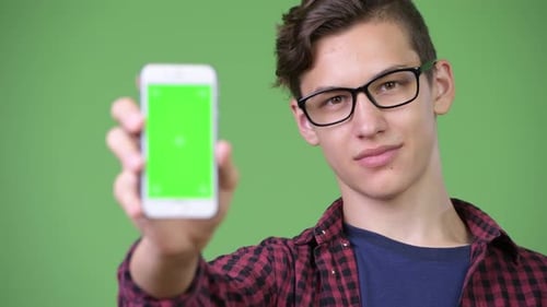 Young Adult Displaying Green Screen Cell Phone