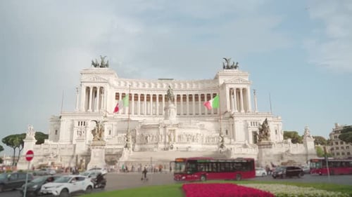 Cars and Buses Drive on Road Against Altar of Fatherland