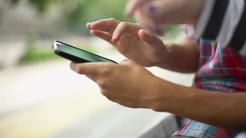 Hands Using Smartphone in Urban Setting