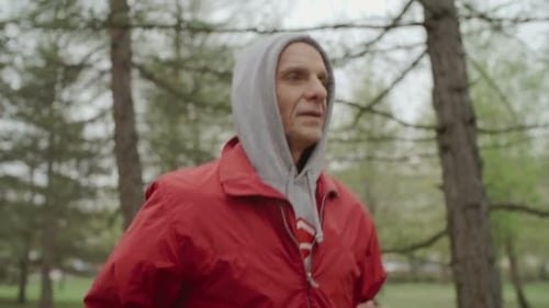 Senior Man Jogging in Park on Overcast Day