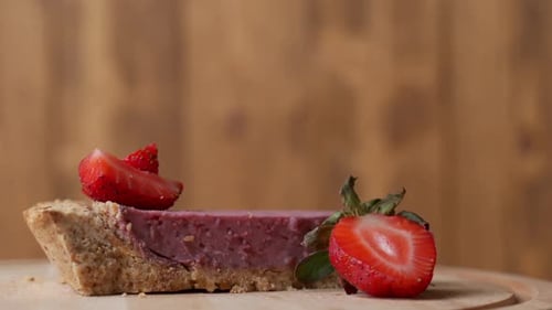 Close-up View of Fresh Strawberries with Slice of Strawberry Cheesecake.