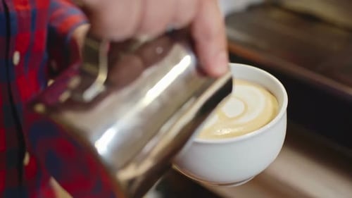 Barista Pouring Steamed Milk for Latte Art