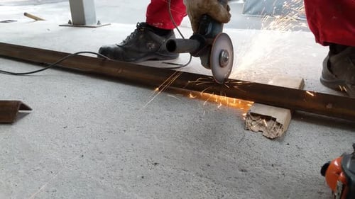 Worker Cutting Metal With An Angle Grinder