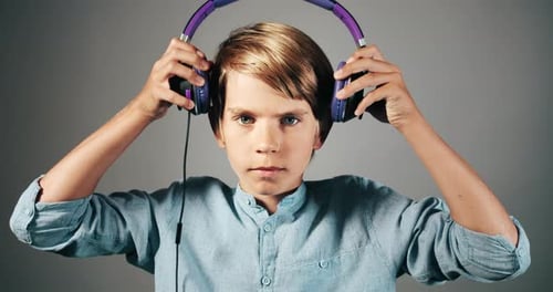 Child puts on purple and black headphones