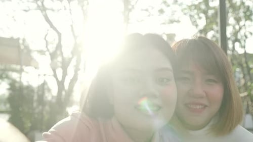 girls couple friend blogger take selfie look at camera with smile face in the city street.