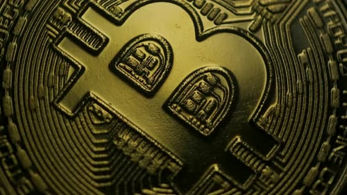 Detail in full frame of rotating golden virtual currency. Macro shot of rotating from virtual crypto