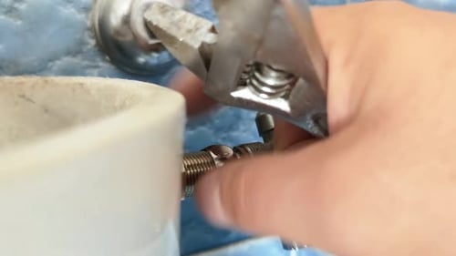 Hand Tightening Nut on Pipe with Wrench