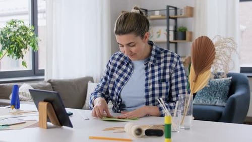 Woman Making Decorative Paper Crafts at Home
