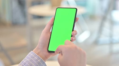 Rear View of Female Hand Using Smartphone with Chroma Screen