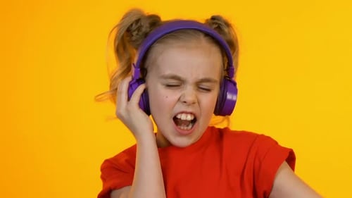 Girl with Headphones Listening to Music and Singing