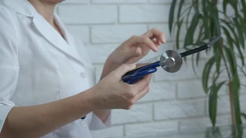 Doctor Uses Tablet With Stethoscope in Hospital