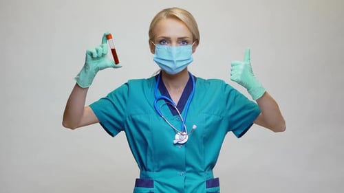 Female Doctor with Test Tube Gives Thumbs Up