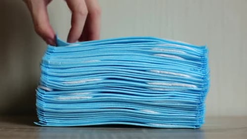 Stack of Light Blue Medical Face Masks