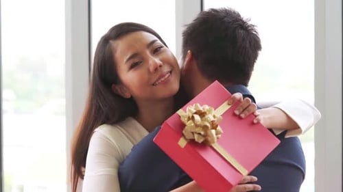 Romantic Couple Giving Gift to Lover at Restaurant