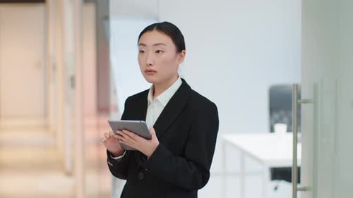 Businesswoman Using Tablet in Modern Office