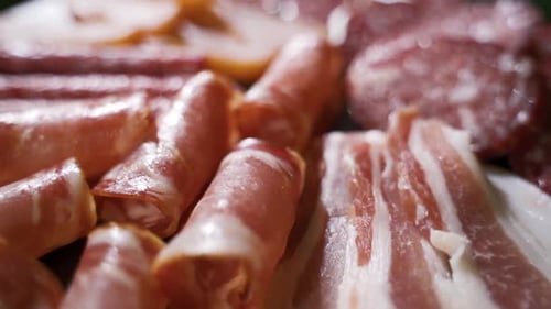 Salami and Chorizo Sausage Close Up on Stone Serving Board