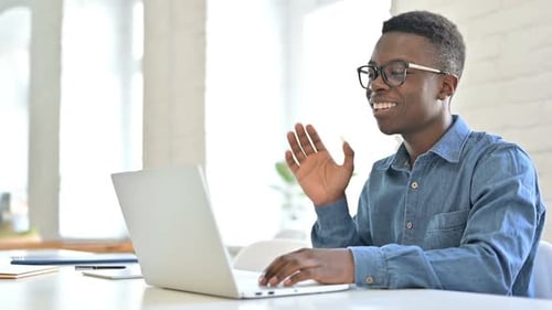 Man Talks on Laptop Video Call Indoors