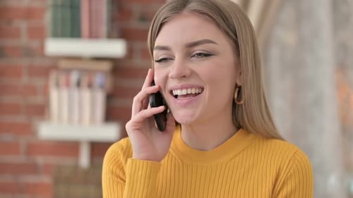 Portrait of Cheerful Young Woman Talking on Smartphone