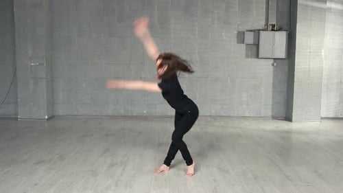 Woman Performing Contemporary Dance Routine in Studio