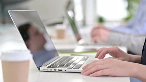 Portrait of Hands of Professionals Using Laptops in Office