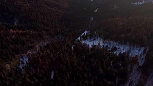 Aerial View of a Rural Landscape with Forests Hills and Snowy Meadows