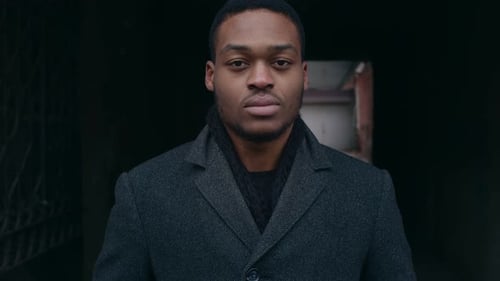 Young Adult in Gray Coat Looking Serious