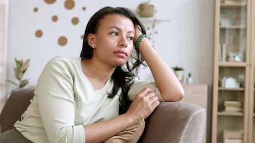 Mixed-race Woman Resting on Sofa