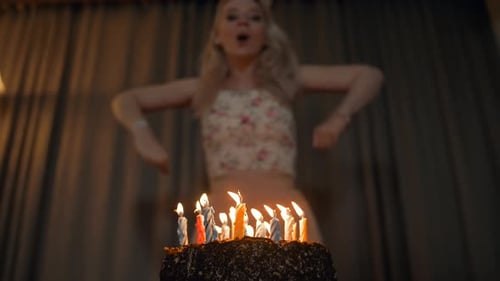 Joyful Woman Celebrates Birthday Blowing Out Candles