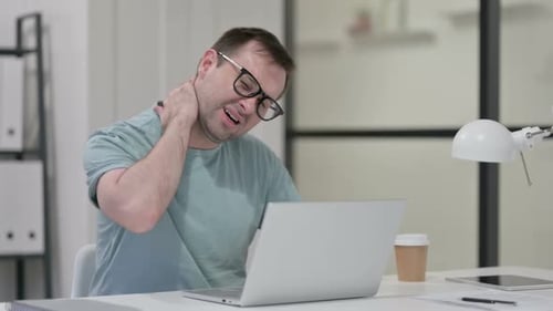 Man Types at Laptop, Experiences Neck Pain