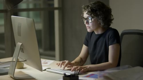 Woman Working at Computer Late at Night