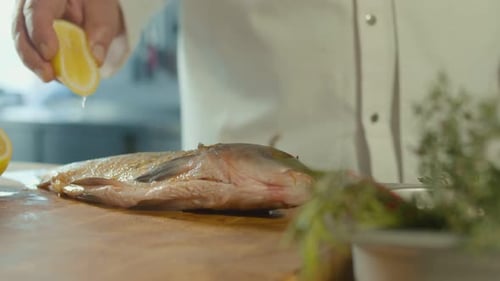 Chef Squeezes Lemon on Fresh Fish