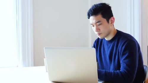 Man working on laptop computer at home