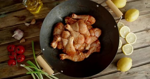Raw Marinated Chicken Drumsticks in Wok Pan