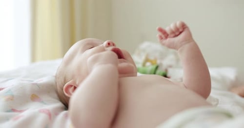 Adorable Baby Lying on Blanket Waving Arms