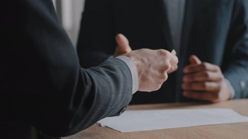 Business People Counting Money and Handshaking