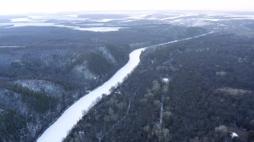 Beautiful flight in winter over snow-covered fields, Winter forest and river from above