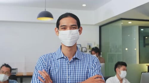 Portrait of young office businesspeople wear face mask working indoor with new normal lifestyle.