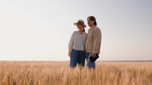 Young Farmers Examing Planted Wheat in the Fields
