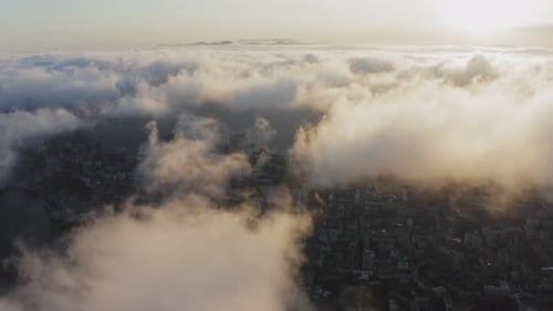 View From a Drone of City Center Above Which Clouds are Rapidly Floating
